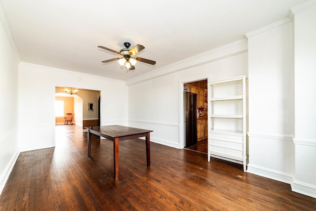 unfurnished dining area with dark wood-type flooring, ornamental molding, and ceiling fan with notable chandelier