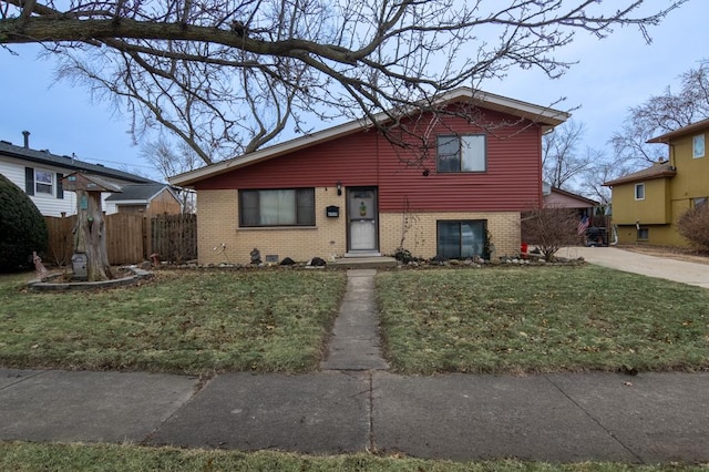 split level home featuring a front lawn