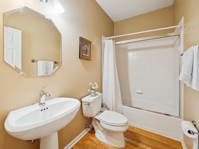 full bathroom with toilet, shower / bath combination with curtain, sink, and hardwood / wood-style floors