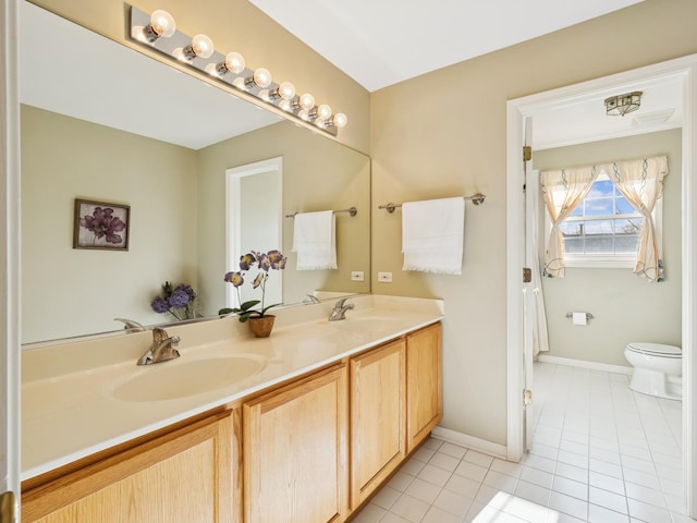 bathroom featuring vanity, tile patterned floors, and toilet