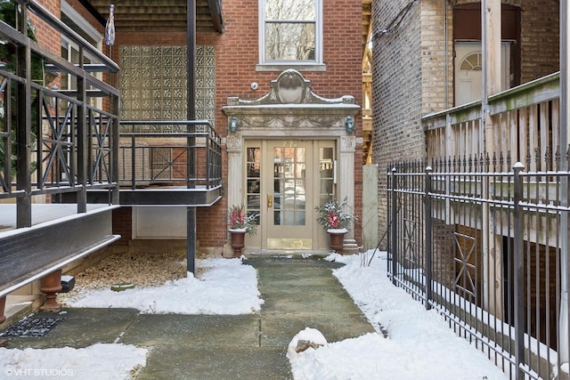 view of snow covered property entrance