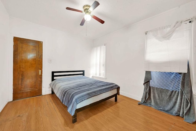 bedroom featuring hardwood / wood-style flooring and ceiling fan