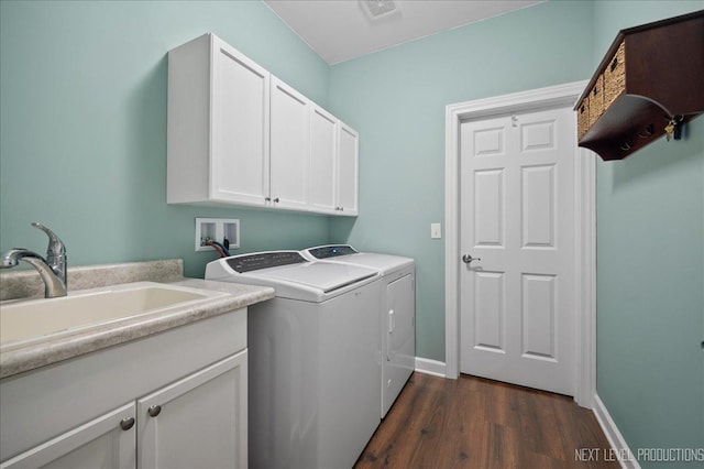 laundry area featuring cabinets, separate washer and dryer, dark hardwood / wood-style floors, and sink