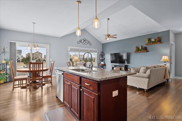 kitchen featuring dark wood-type flooring, stainless steel dishwasher, a kitchen island with sink, and sink