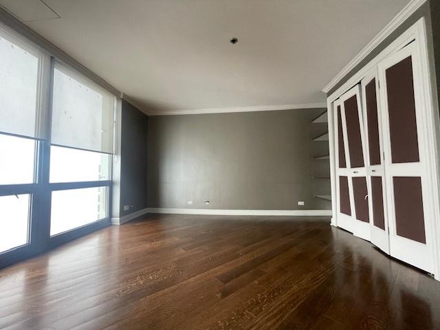 empty room featuring ornamental molding and dark hardwood / wood-style floors