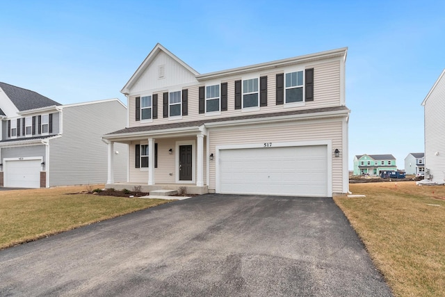 view of front of house featuring a garage, covered porch, and a front lawn