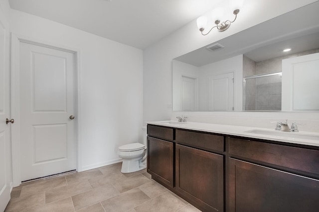 bathroom featuring vanity, toilet, and a shower with door