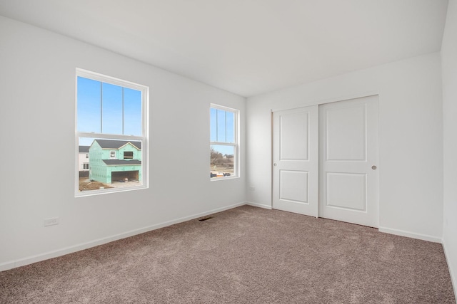 unfurnished bedroom featuring carpet floors and a closet