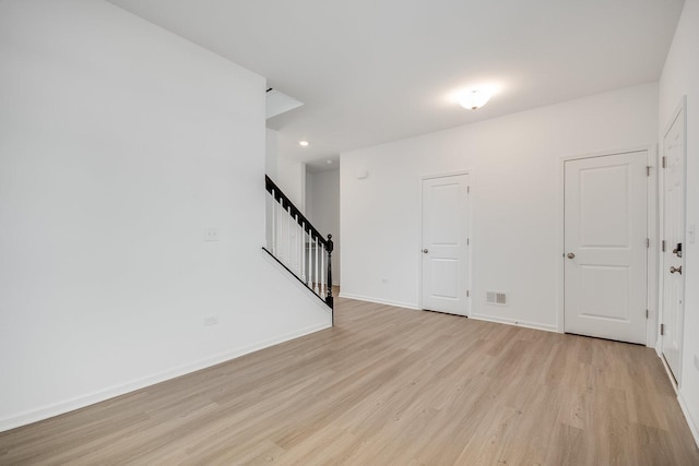 spare room featuring light wood-type flooring