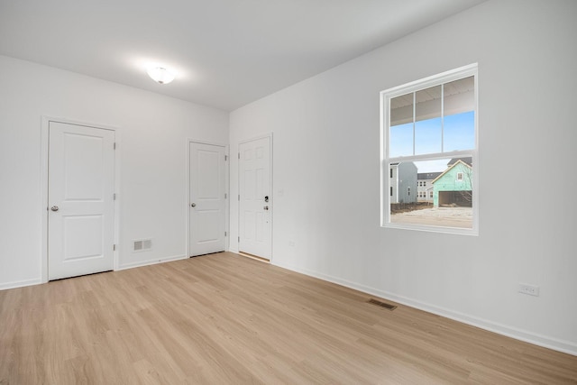 spare room with light hardwood / wood-style flooring