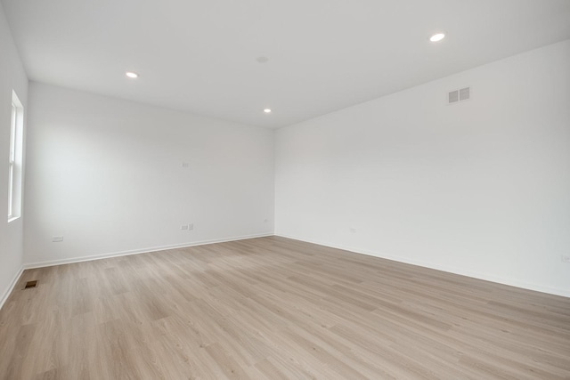 spare room featuring light hardwood / wood-style floors