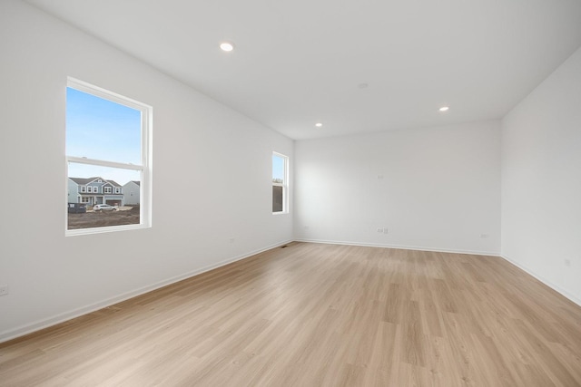 unfurnished room with light hardwood / wood-style flooring