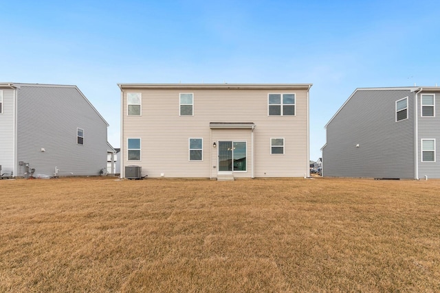 back of house featuring central AC and a yard