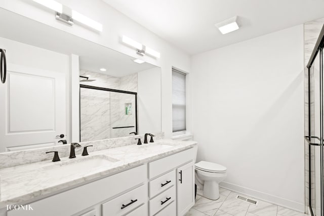 bathroom with walk in shower, vanity, and toilet