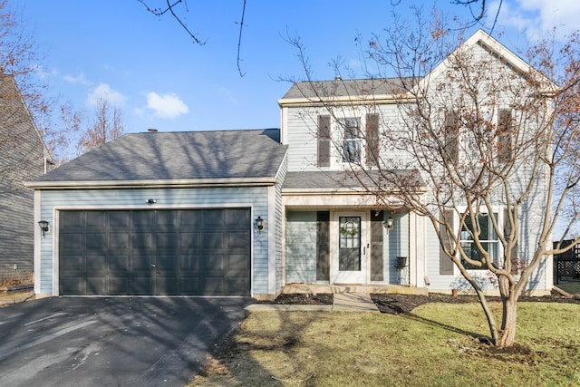 view of front of house with a garage and a front lawn