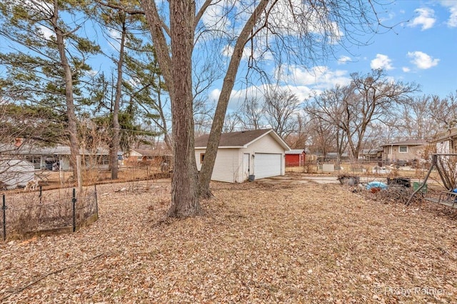 view of yard featuring a garage and fence