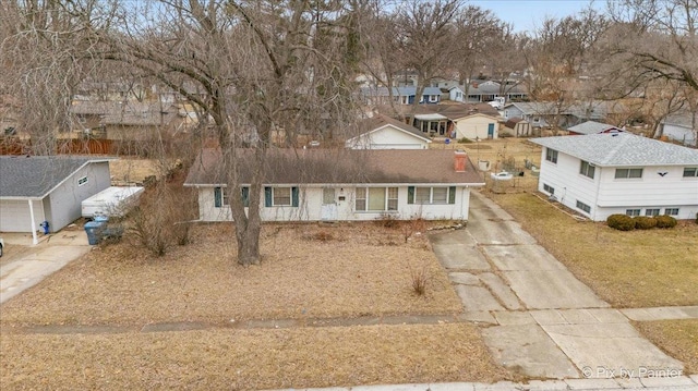 view of front of property featuring a residential view and driveway