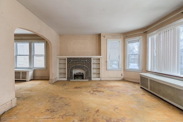 unfurnished living room with radiator heating unit