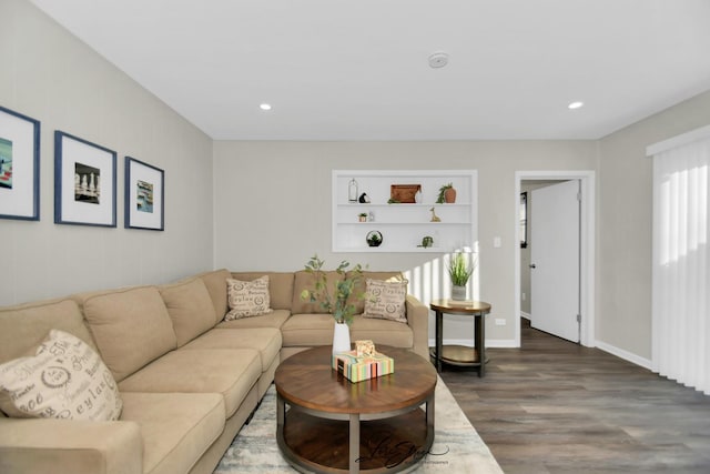 living room with hardwood / wood-style flooring and built in features