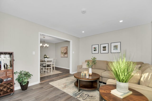 living room with an inviting chandelier and hardwood / wood-style floors