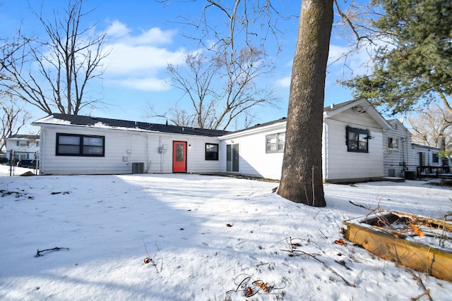 snow covered house featuring central AC