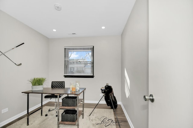 home office with light hardwood / wood-style flooring