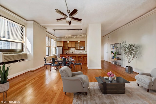 living room featuring crown molding, cooling unit, track lighting, hardwood / wood-style flooring, and ceiling fan