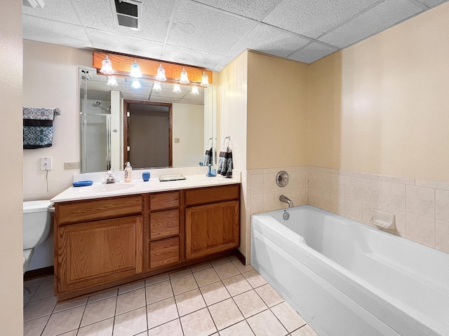 full bathroom with toilet, a paneled ceiling, shower with separate bathtub, vanity, and tile patterned flooring