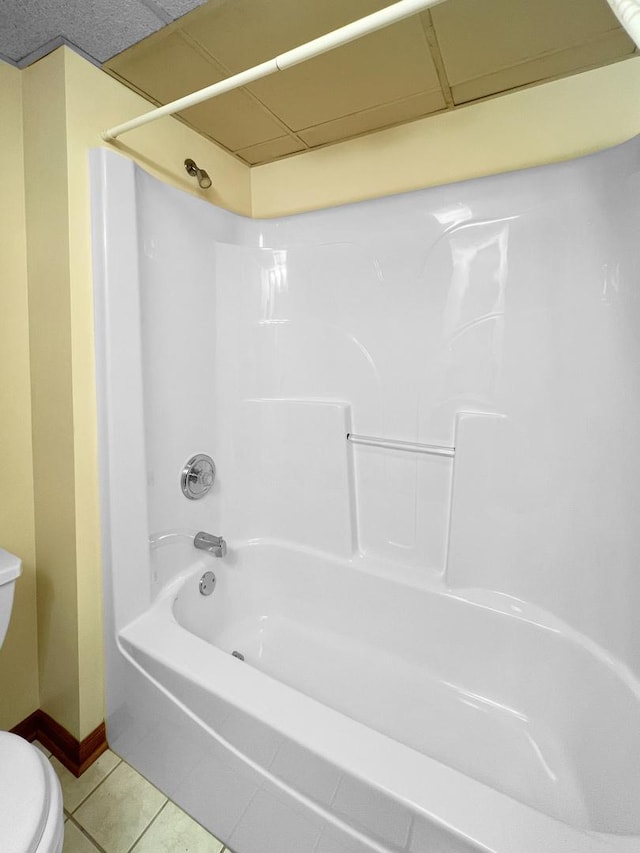 bathroom featuring tile patterned flooring, toilet, and shower / bath combination