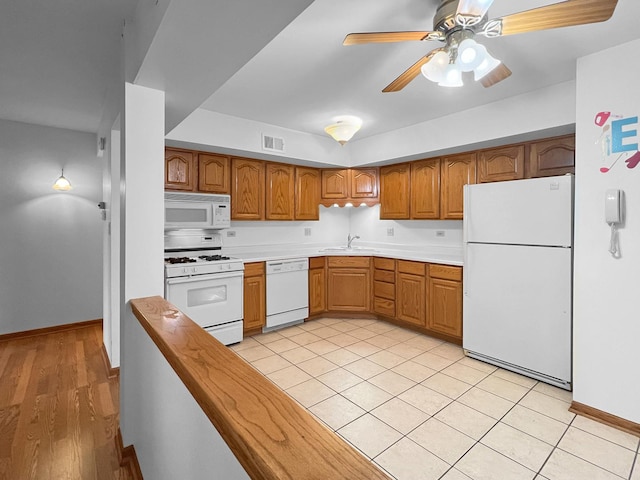 kitchen featuring sink, white appliances, and ceiling fan