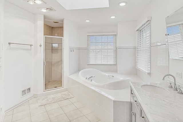 bathroom with vanity, independent shower and bath, and tile patterned flooring