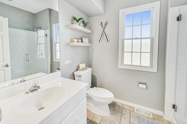 bathroom featuring vanity, a shower with door, and toilet