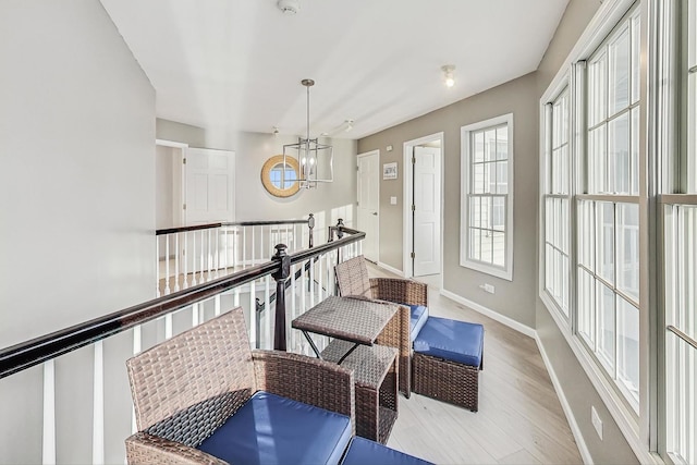 interior space featuring an inviting chandelier and light wood-type flooring