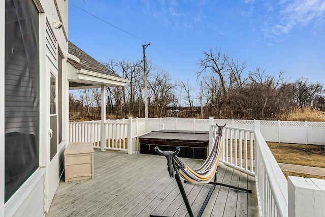 wooden deck with a hot tub