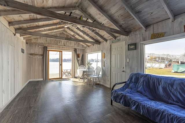 interior space with vaulted ceiling with beams, wood ceiling, and wood walls