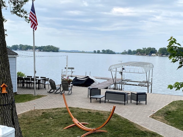 dock area featuring a water view and a lawn