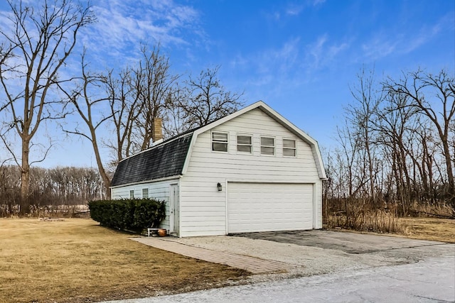 exterior space with a garage and an outdoor structure