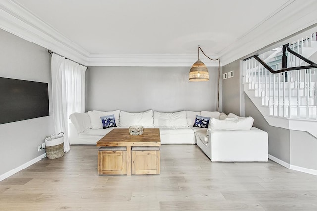 living room with hardwood / wood-style floors and ornamental molding