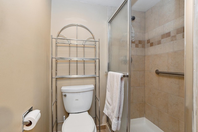 bathroom featuring an enclosed shower and toilet