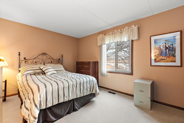 bedroom featuring light carpet