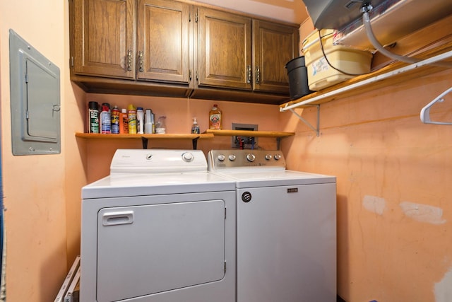 clothes washing area with cabinets, electric panel, and independent washer and dryer