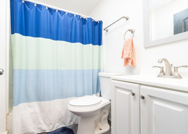 bathroom featuring vanity, toilet, and a shower with shower curtain