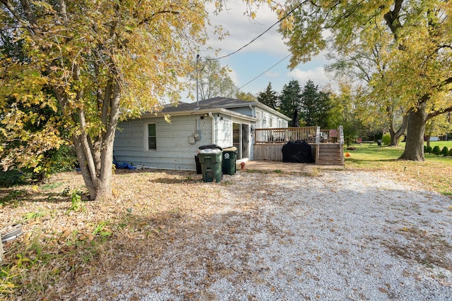 view of home's exterior with a wooden deck