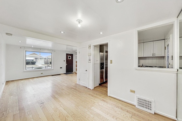 unfurnished living room with light wood-type flooring