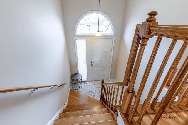 stairway with tile patterned floors