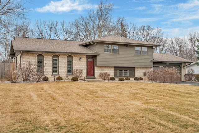 split level home with a garage and a front yard