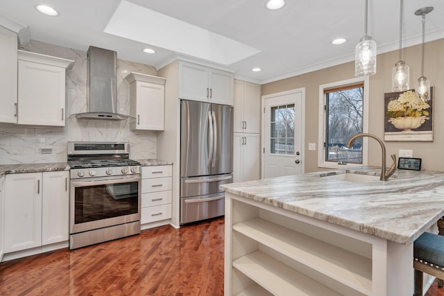 kitchen with white cabinetry, appliances with stainless steel finishes, and wall chimney range hood