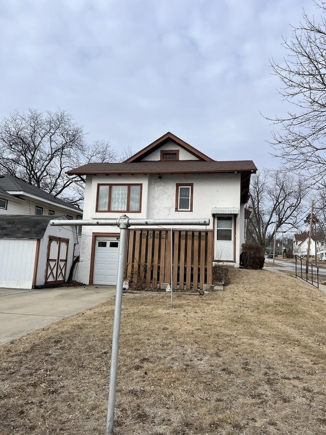 view of front of home with a garage and a storage unit