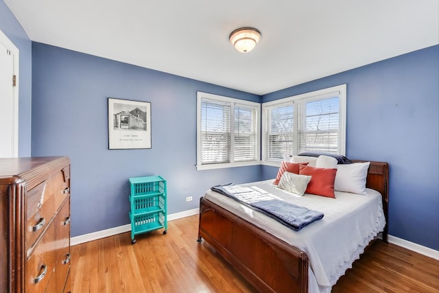 bedroom with baseboards and wood finished floors