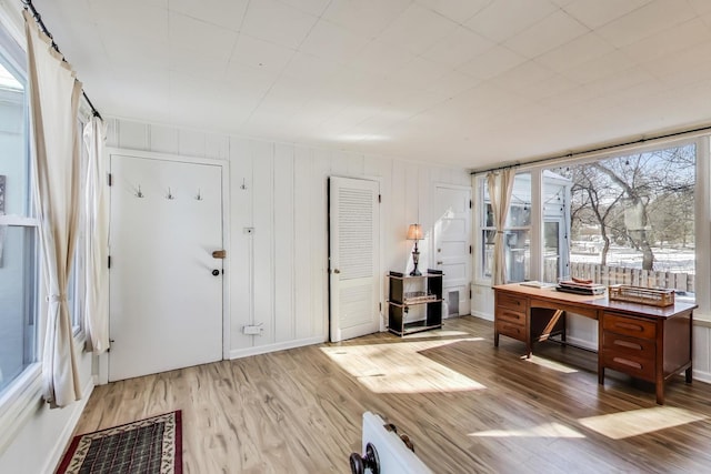 home office with light wood-style floors and baseboards